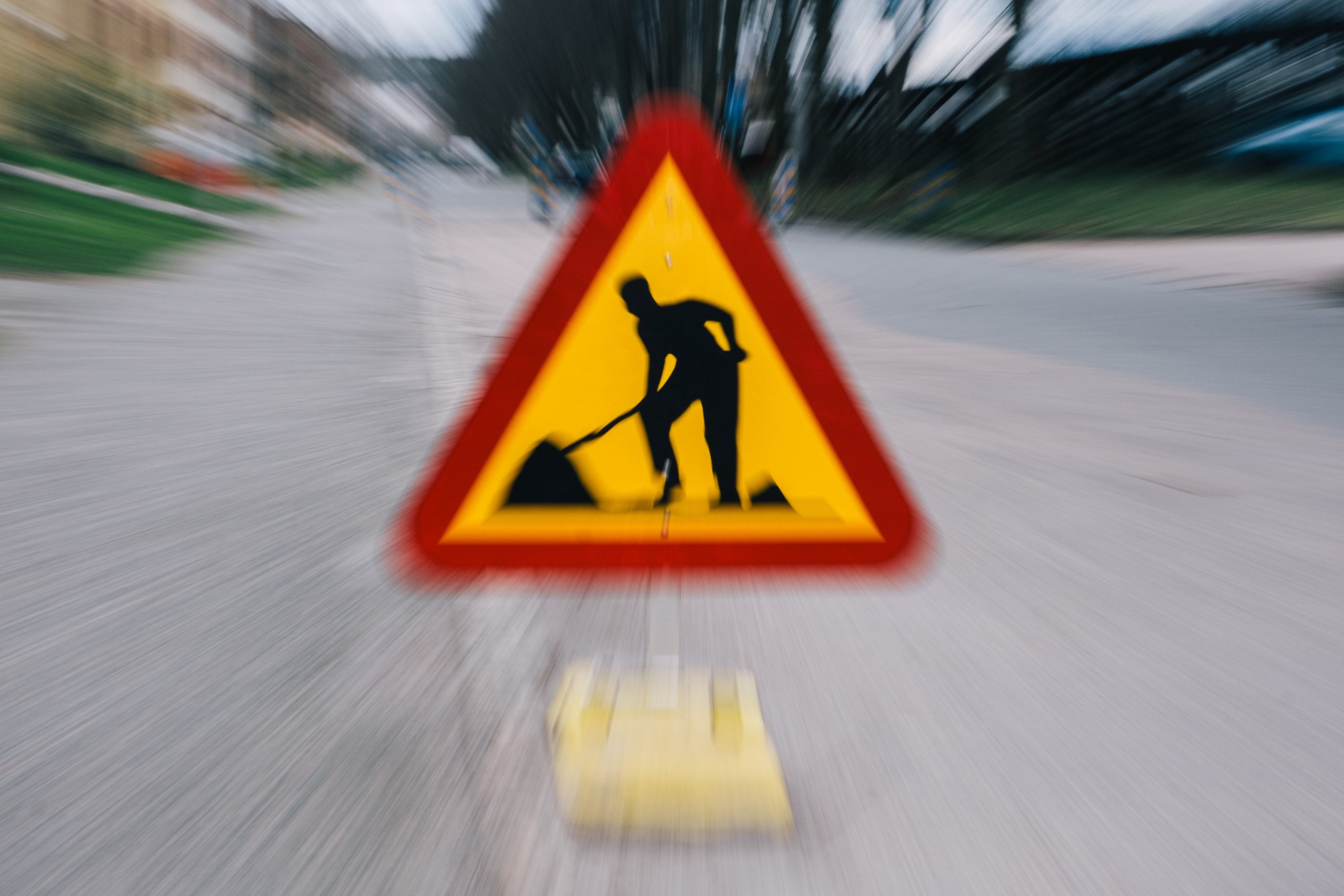 Två bilar syns köra från Cronackersgatan mot rondellen i Eriksbergsmotet. E gångtrafikant går på Cronackersbron mot Lindholmen.